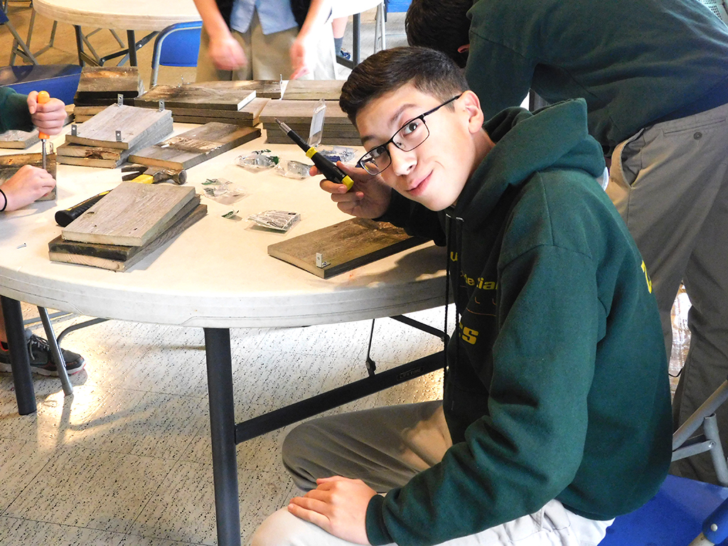 9th Grader Constructing 20 Year Celebration Centerpieces